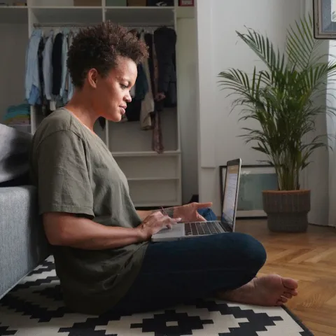 A woman doing research on her computer.