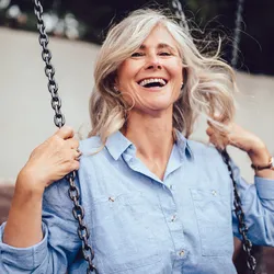 Picture of a woman swinging on a swing.