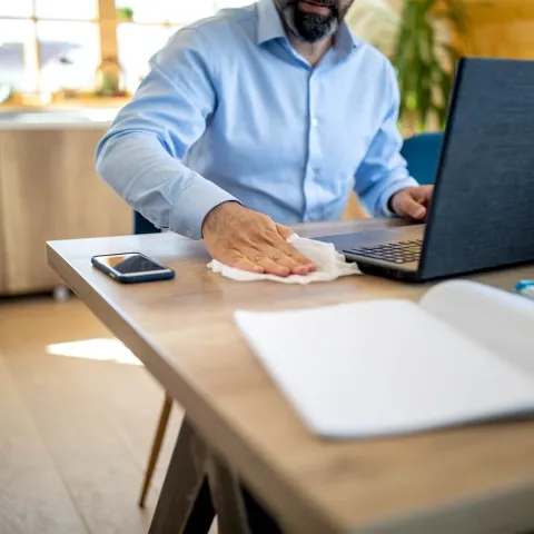 A man wiping down his work station.