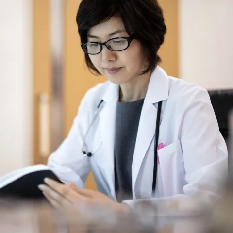 A female doctor reviews materials. 