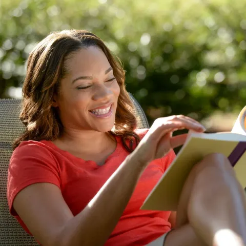 woman outside reading a book