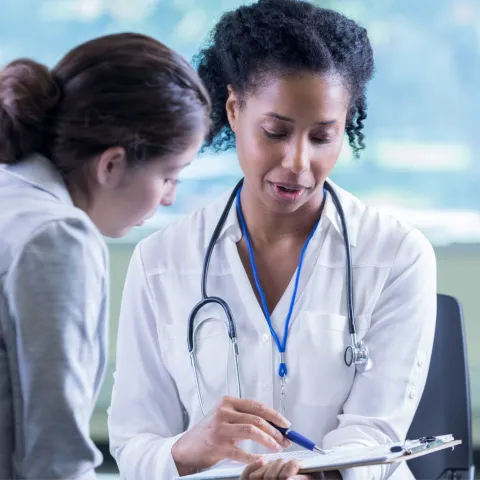 A physician talking with her patient.