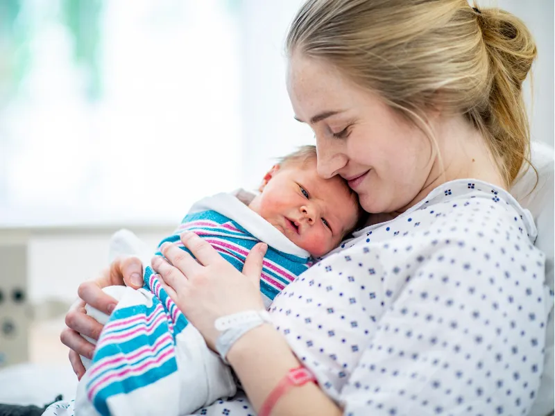 A mom holding her newborn.