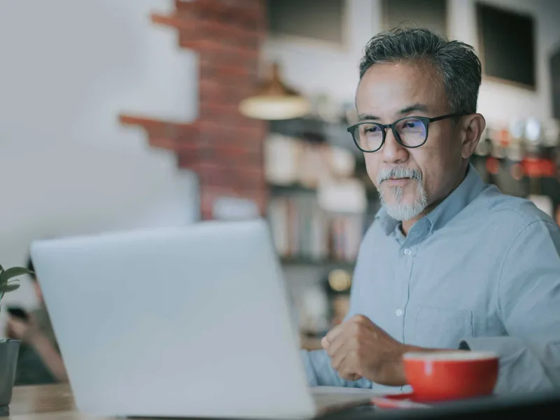 An mature man on his laptop