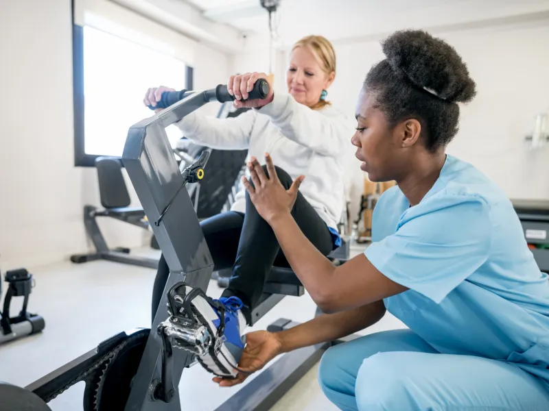 A Therapist Helps a Patient Through a Physical Therapy Session.