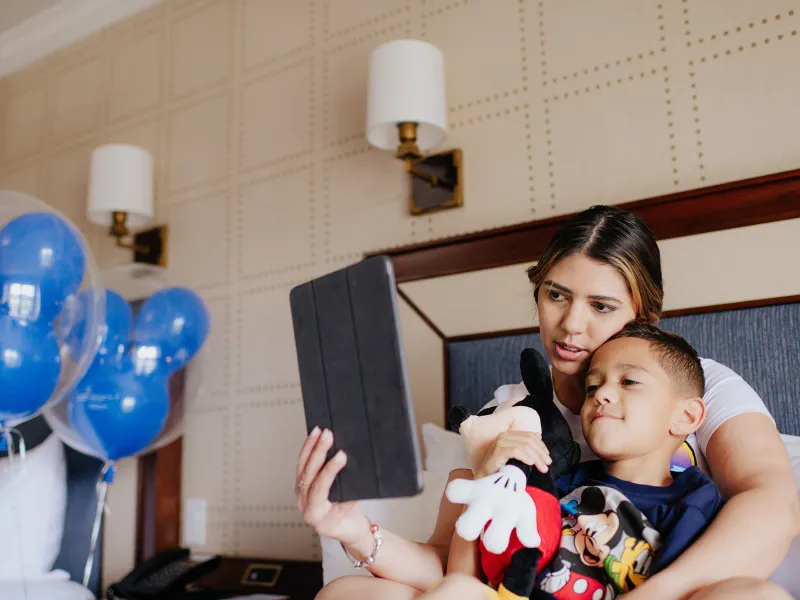 Mother and child using tablet for a video visit.