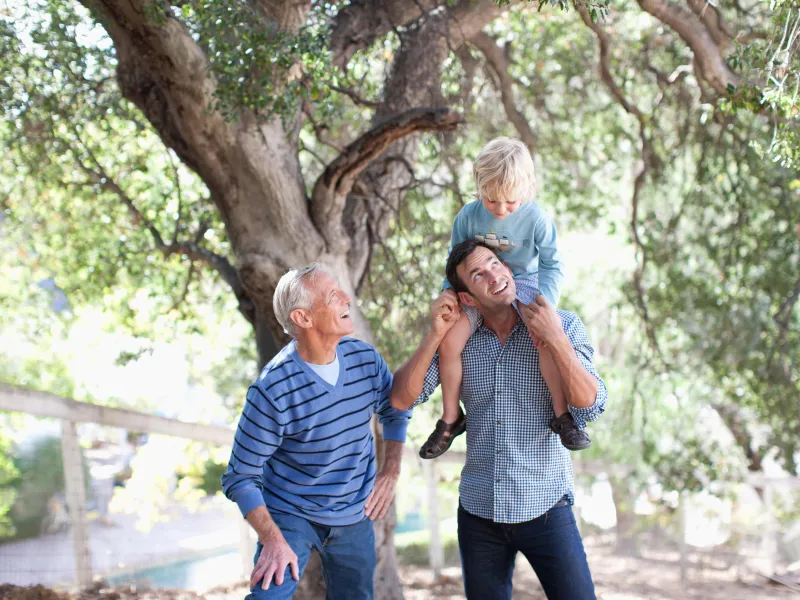 Father, son and grandfather spending time together outside.