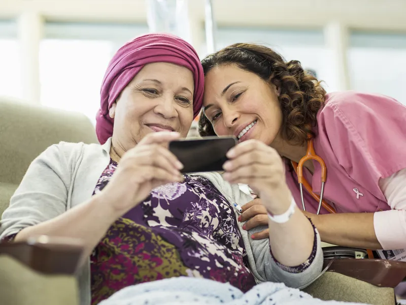 A young nurse and her female cancer patient taking a sweet selfie.