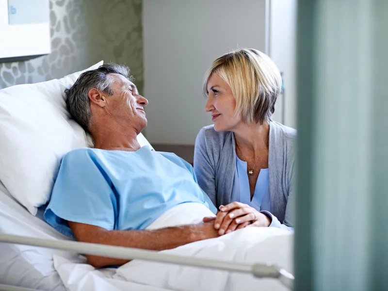 Woman visiting husband in the hospital.