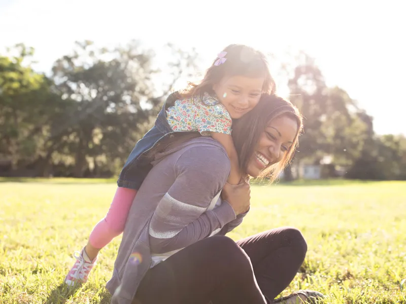 Daughter climbing on her favorite jungle-gym: her mother.