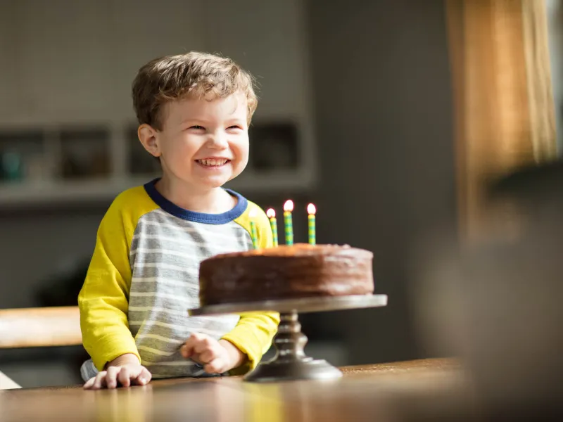 Child excited for his birthday cake