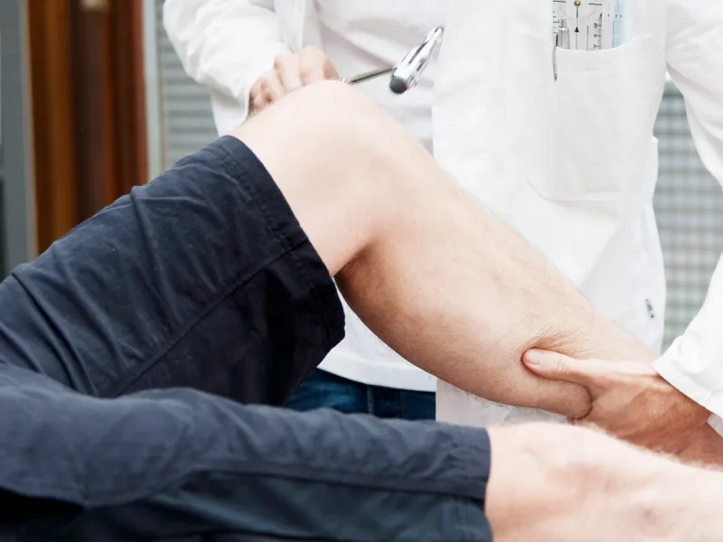 Doctor examining patient's knee