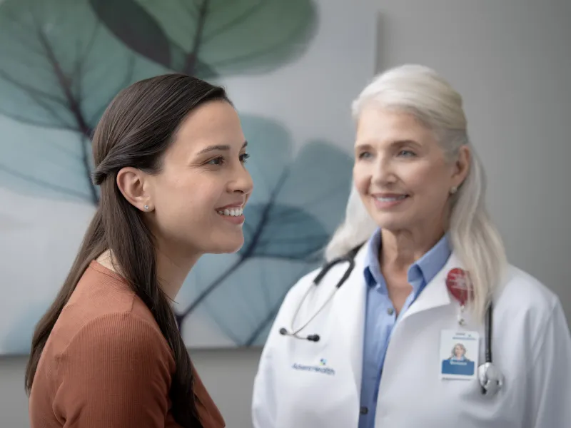 Young female patient with older female physician in an exam room.