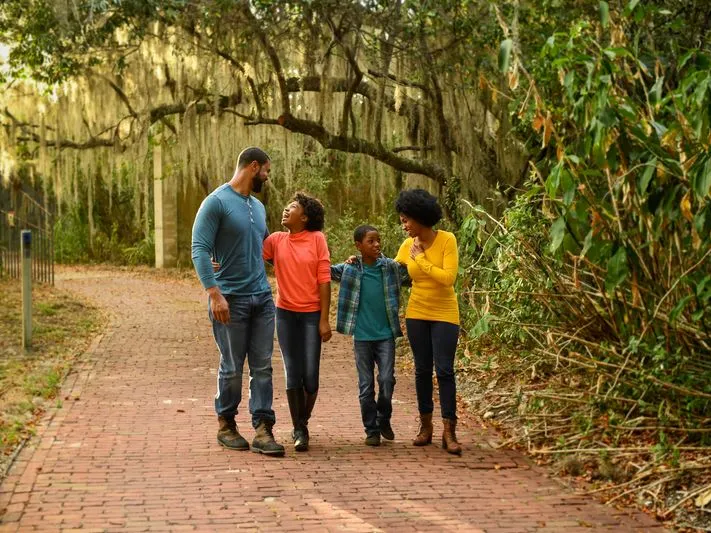 A family walks through the trees