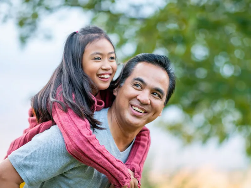 father-carrying-his-daughter-on-his-back