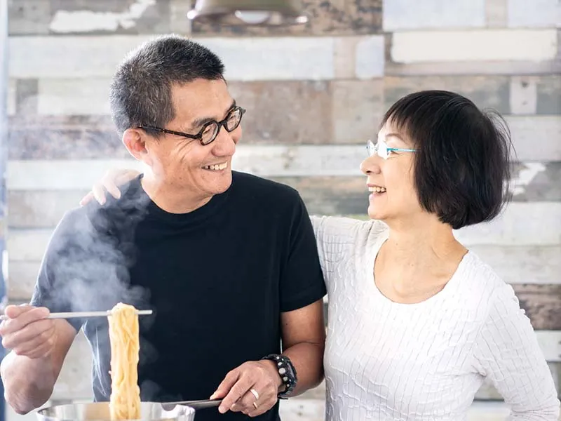 Asian couple cooking together