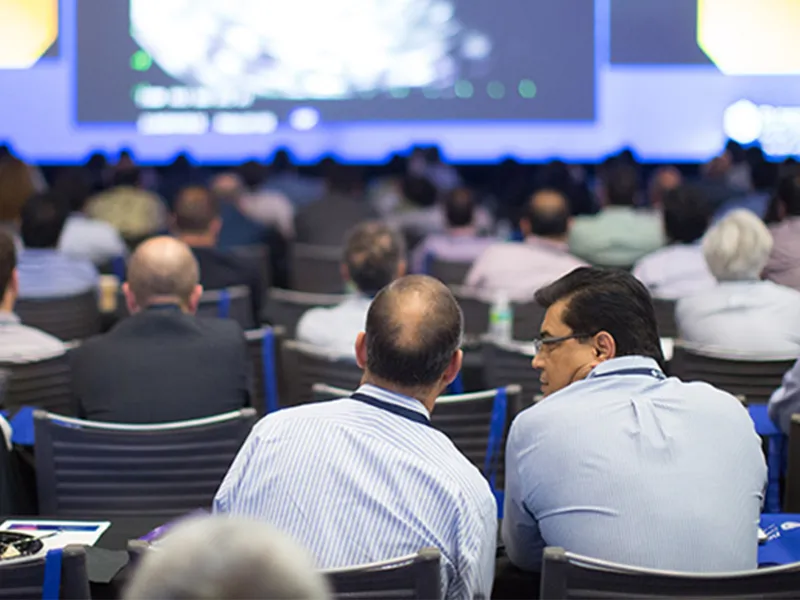 Audience watching presentation in Nicholson Center Education Center room.