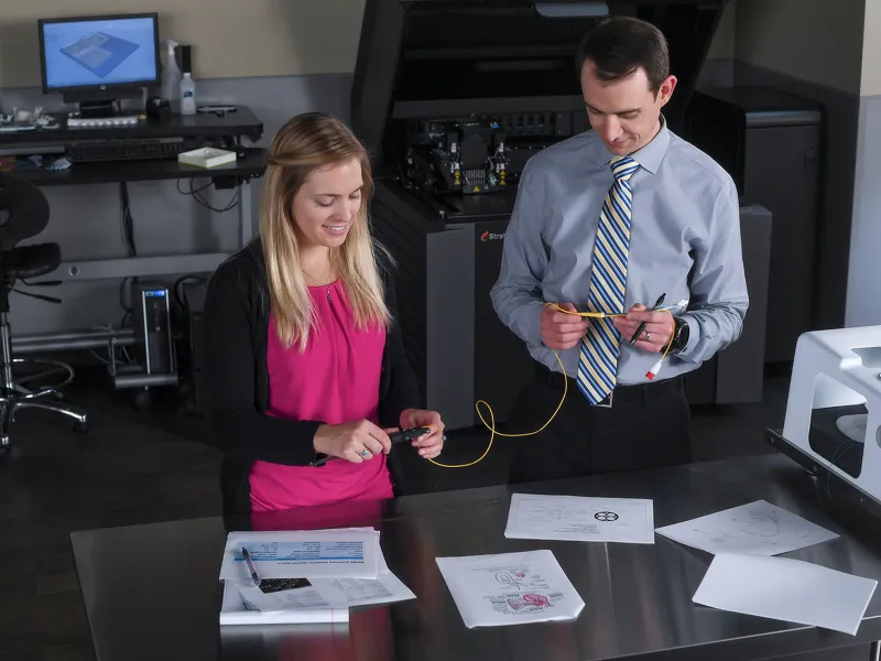 Two professionals working in the Nicholson Center prototype lab.