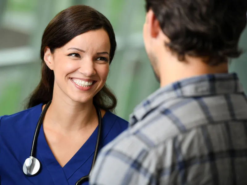 A nurse talking to a patient at the hospital.