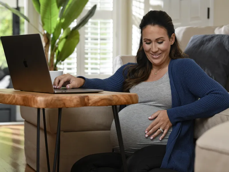 Pregnant woman using a laptop