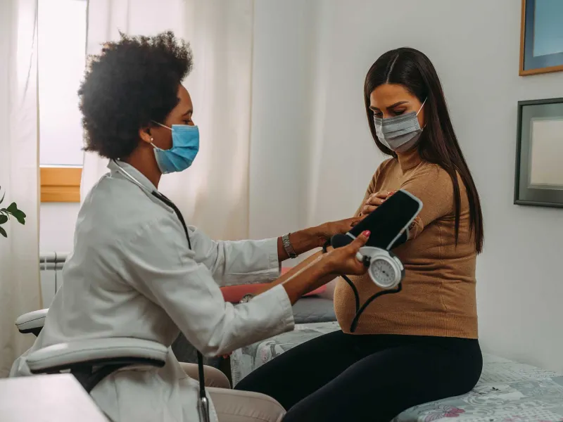 A woman getting a test done by her doctor