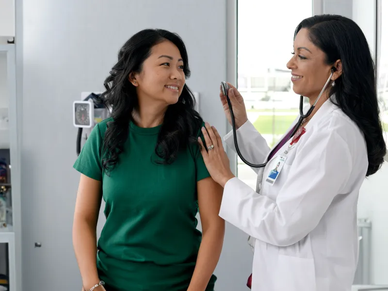 Primary Care Plus Provider with patient in clinic