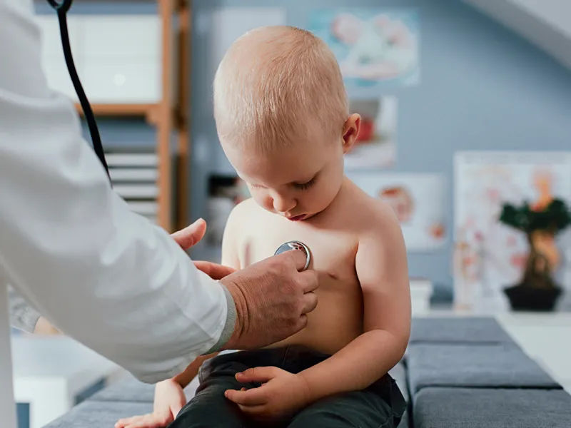 AdventHealth physician checks young boy’s heart with stethoscope