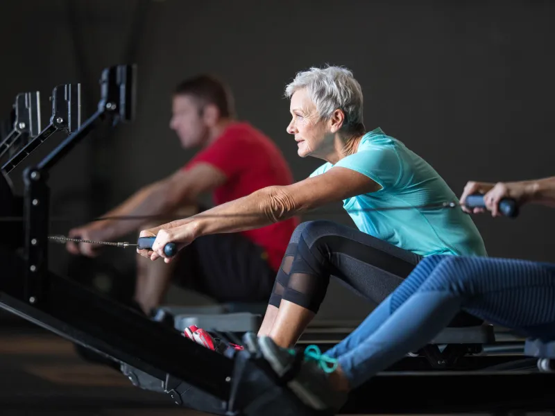 Woman on a rowing machine.