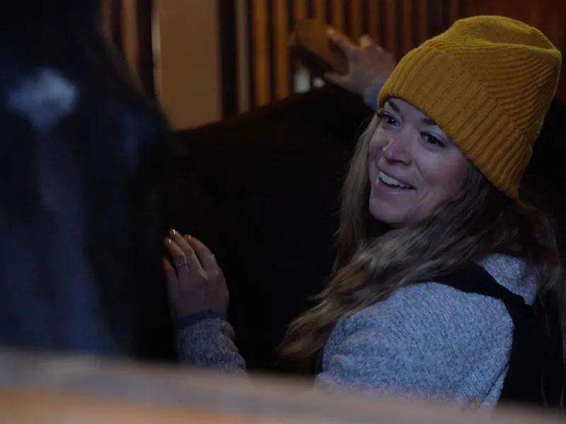 Woman grooming her horse.