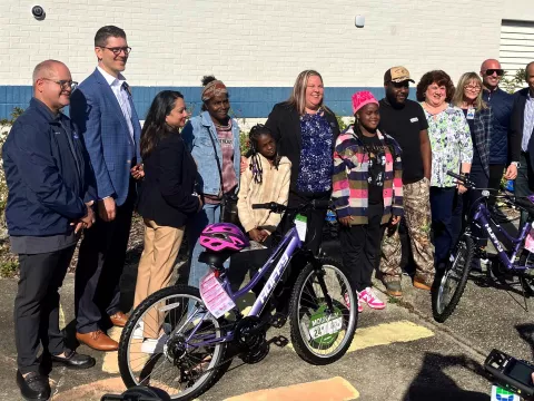 AdventHealth and Volusia County Schools leaders present free bikes to first of nearly 170 students.