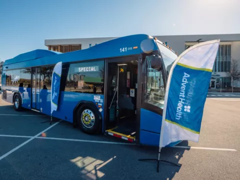 A newly AED-equipped LYNX LYMMO bus at an AdventHealth press event with the American Heart Association.