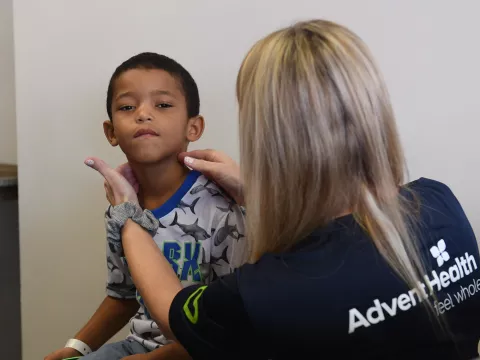 AdventHealth doctor conducts school entry physical on child 