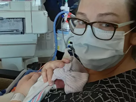 Family relied on video and photo updates from NICU nurses due to COVID-19 restrictions.