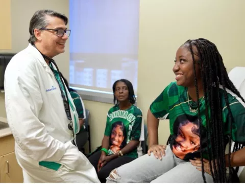 Jermila Pompey, and her family, with Dr. Michael Angelis, at AdventHealth Transplant Institute.