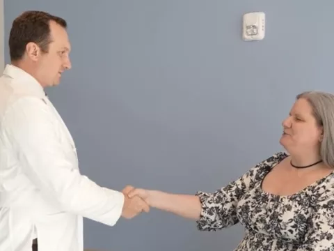 Dr. A.J. Clair talks to patient, Jean McMichael, during an office visit at Rothman Orthopaedics at AdventHealth Innovation Tower