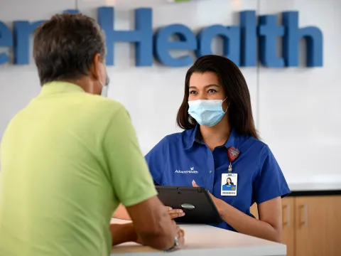 An AdventHealth employee helping out a gentleman