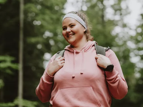 A Woman Hikes Through the Woods
