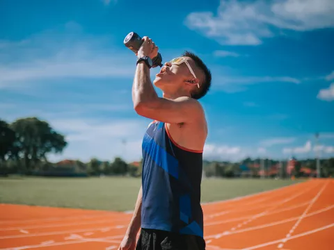 A young, asian adult on a water break