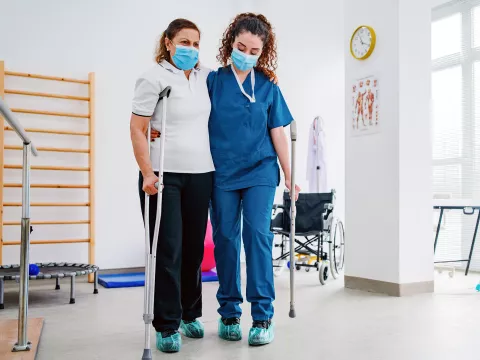 A Physical Therapist Helps a Patient During a Session.