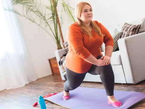 A Woman Stretches During Yoga in Her Home