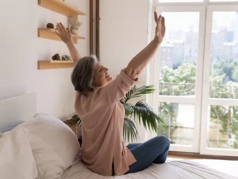 A Woman Stretches After Waking From Sleep