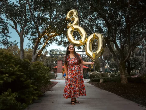 Jenn poses for a photo with balloons