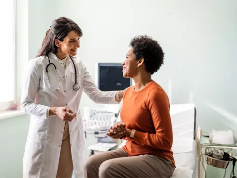 A Provider Speaks to a Patient in an Exam Room