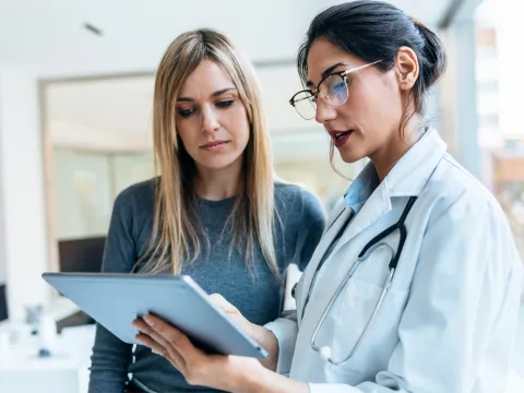 A Provider Goes Over a Patient's Chart with Her.