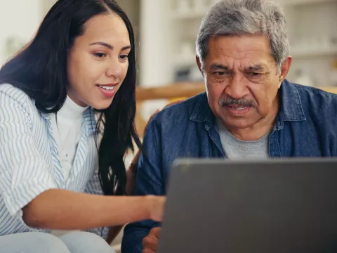 A Daughter Helps Her Senior Father on His Laptop