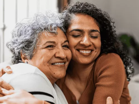 A Daughter Hugs Her Senior Mom at Home