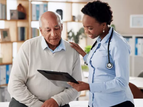 A Doctor Goes Over a Chart with a Patient