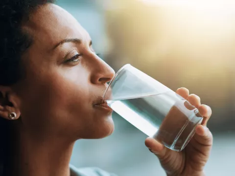 A Close Up of a Woman Drinking Water