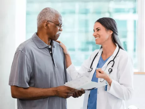 Man with doctor reviewing pamphlet