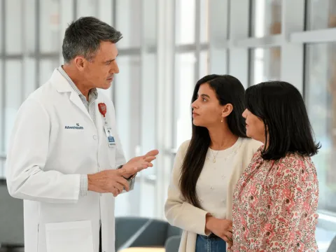 A Physician Speaks with Two Patients in a Waiting Room